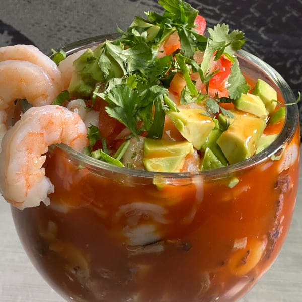 A glass of 7 Mares Mexican Restaurant's shrimp cocktail with avocado, cilantro, and tomato.