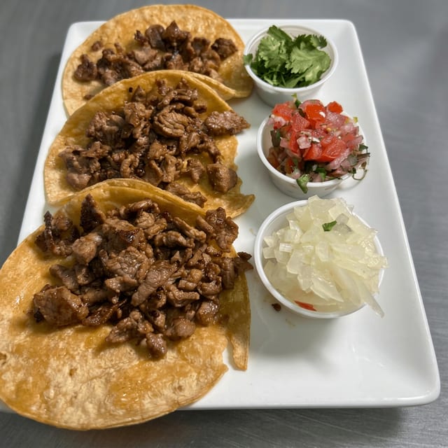 Tacos De Carne Asada or Chicken Y Carnitas.